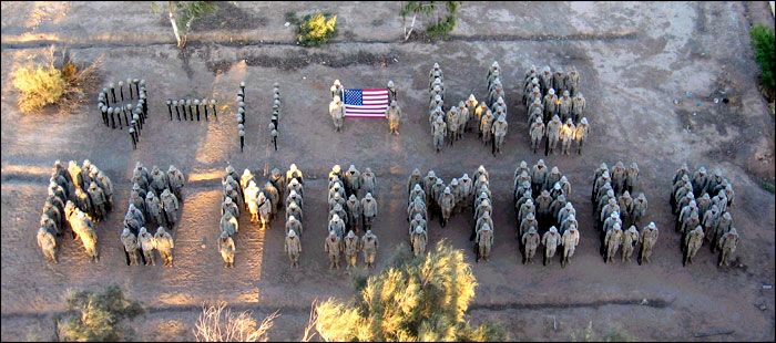 People arranged in such a fashion as to spell out 9-11 We Remember